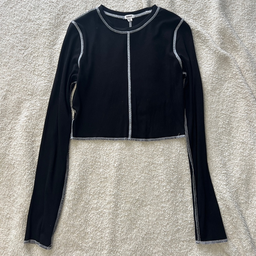 Medium garage black long sleeve cropped with white seams.